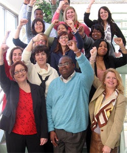 Employees of the Wisconsin Women's Business Initiative Corporation wearing their Create Jobs for USA wristbands.