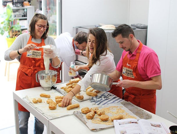 Paris HQ is tasty: Staffers prep vanilla ?clairs days before their mandated pastry exam.