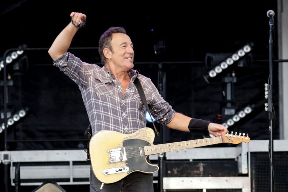 Bruce Springsteen invites a fan to play onstage.