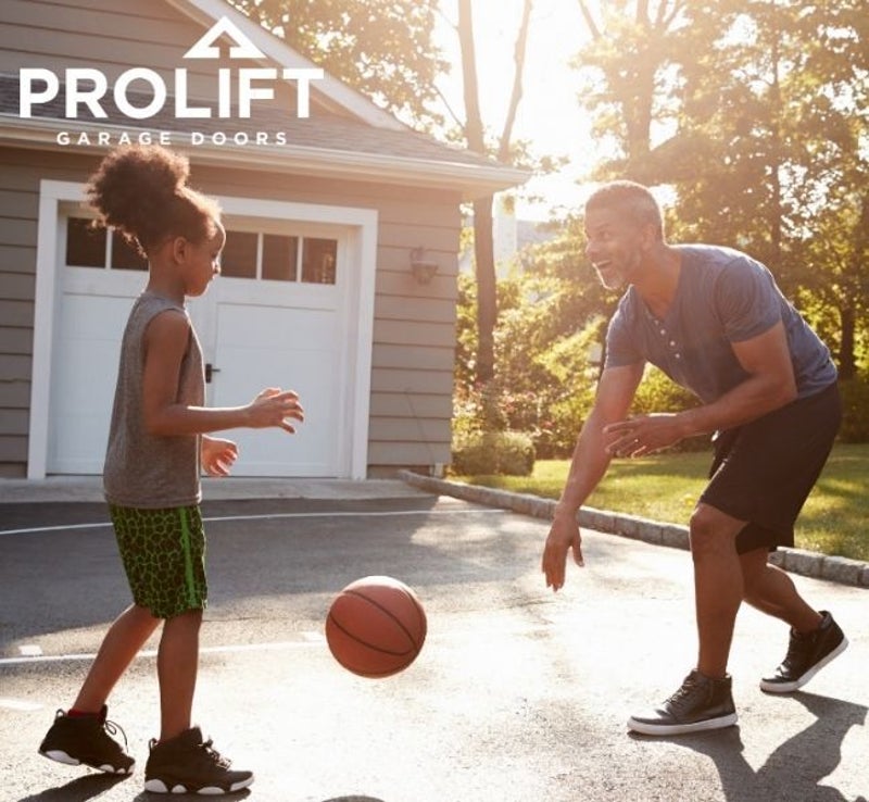dad and daughter playing basketball